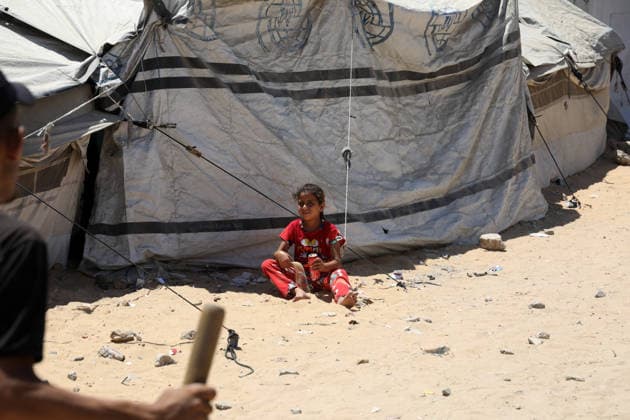 Displaced children play among ruins in western Gaza City Palestinian children play near tents sheltering displaced families amid the rubble of destroyed buildings in western Gaza City on June 15, 2026, as temperatures rise and humanitarian conditions continue to deteriorate. Displaced residents face growing challenges due to damaged infrastructure and shortages of basic services, while cases of skin diseases among children are increasing in displacement camps and shelters across the Gaza Strip. Photo by Bilal Osama apaimages Gaza city Gaza Strip Palestinian Territory 150626_Gaza_BO_02(14) Copyright: xapaimagesxBilalxOsamax xapaimagesx
