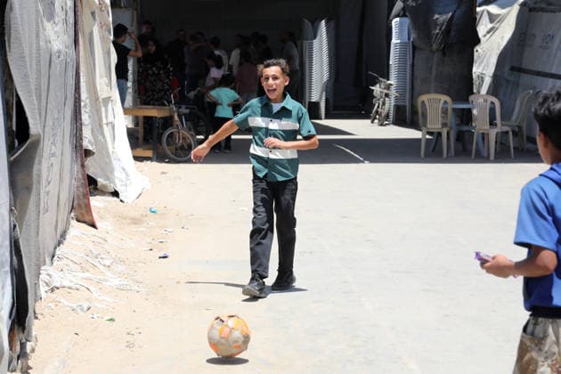 Displaced children play among ruins in western Gaza City Palestinian children play near tents sheltering displaced families amid the rubble of destroyed buildings in western Gaza City on June 15, 2026, as temperatures rise and humanitarian conditions continue to deteriorate. Displaced residents face growing challenges due to damaged infrastructure and shortages of basic services, while cases of skin diseases among children are increasing in displacement camps and shelters across the Gaza Strip. Photo by Bilal Osama apaimages Gaza city Gaza Strip Palestinian Territory 150626_Gaza_BO_02(4) Copyright: xapaimagesxBilalxOsamax xapaimagesx
