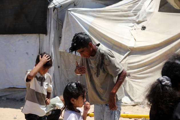 Displaced children play among ruins in western Gaza City Palestinian children play near tents sheltering displaced families amid the rubble of destroyed buildings in western Gaza City on June 15, 2026, as temperatures rise and humanitarian conditions continue to deteriorate. Displaced residents face growing challenges due to damaged infrastructure and shortages of basic services, while cases of skin diseases among children are increasing in displacement camps and shelters across the Gaza Strip. Photo by Bilal Osama apaimages Gaza city Gaza Strip Palestinian Territory 150626_Gaza_BO_02(8) Copyright: xapaimagesxBilalxOsamax xapaimagesx
