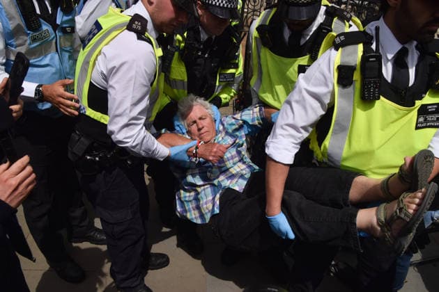June 15, 2026, London, England, United Kingdom: Police officers arrest a protester outside the Royal Courts of Justice as the ban on the activist group Palestine Action is ruled as lawful by the Court of Appeal. Judges have overturned a previous ruling that the ban on the group was wrong. Protesters sat outside the court with placards stating Ã¢â‚¬ËœSaving lives is not terrorism, I support Palestine ActionÃ¢ London United Kingdom  - ZUMAv130 20260615_zip_v130_004 Copyright: xVukxValcicx