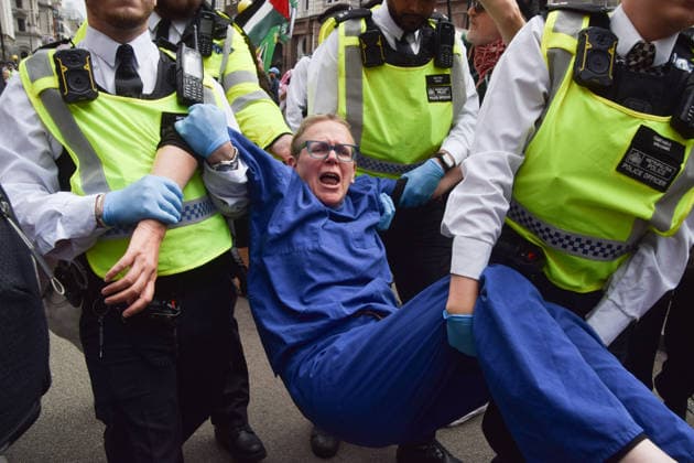 June 15, 2026, London, England, United Kingdom: Police officers arrest a protester outside the Royal Courts of Justice as the ban on the activist group Palestine Action is ruled as lawful by the Court of Appeal. Judges have overturned a previous ruling that the ban on the group was wrong. Protesters sat outside the court with placards stating Ã¢â‚¬ËœSaving lives is not terrorism, I support Palestine ActionÃ¢ London United Kingdom  - ZUMAv130 20260615_zip_v130_009 Copyright: xVukxValcicx