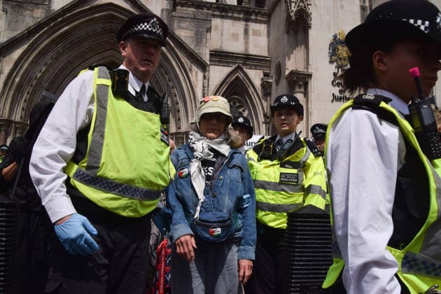 June 15, 2026, London, England, United Kingdom: Police officers arrest a protester outside the Royal Courts of Justice as the ban on the activist group Palestine Action is ruled as lawful by the Court of Appeal. Judges have overturned a previous ruling that the ban on the group was wrong. Protesters sat outside the court with placards stating Ã¢â‚¬ËœSaving lives is not terrorism, I support Palestine ActionÃ¢ London United Kingdom  - ZUMAv130 20260615_zip_v130_010 Copyright: xVukxValcicx