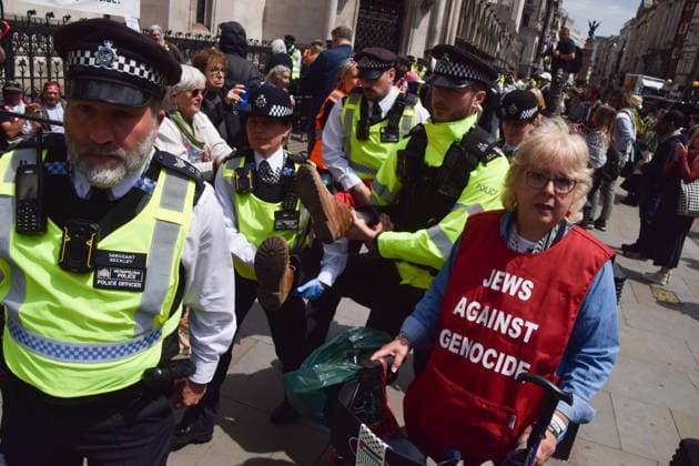 June 15, 2026, London, England, United Kingdom: Police officers arrest a protester outside the Royal Courts of Justice as the ban on the activist group Palestine Action is ruled as lawful by the Court of Appeal. Judges have overturned a previous ruling that the ban on the group was wrong. Protesters sat outside the court with placards stating Ã¢â‚¬ËœSaving lives is not terrorism, I support Palestine ActionÃ¢ London United Kingdom  - ZUMAv130 20260615_zip_v130_012 Copyright: xVukxValcicx
