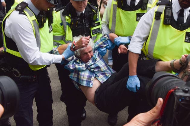 June 15, 2026, London, England, United Kingdom: Police officers arrest a protester outside the Royal Courts of Justice as the ban on the activist group Palestine Action is ruled as lawful by the Court of Appeal. Judges have overturned a previous ruling that the ban on the group was wrong. Protesters sat outside the court with placards stating Ã¢â‚¬ËœSaving lives is not terrorism, I support Palestine ActionÃ¢ London United Kingdom - ZUMAv130 20260615_zip_v130_008 Copyright: xVukxValcicx