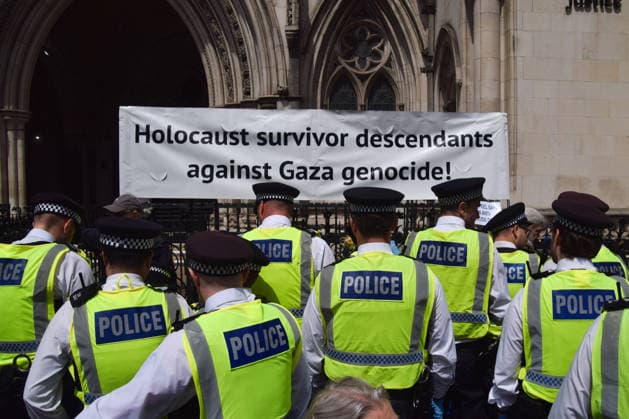 June 15, 2026, London, England, United Kingdom: Police officers arrest protesters sitting under a banner stating Holocaust survivor descendants against Gaza genocde outside the Royal Courts of Justice as the ban on the activist group Palestine Action is ruled as lawful by the Court of Appeal. Judges have overturned a previous ruling that the ban on the group was wrong. Protesters sat outside the court with placards stating Ã¢â‚¬ËœSaving lives is not terrorism, I support Palestine ActionÃ¢ London United Kingdom - ZUMAv130 20260615_zip_v130_014 Copyright: xVukxValcicx