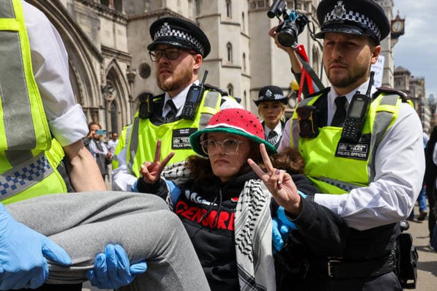 June 15, 2026, London, London, UK: London, UK. Police officers detain a woman during a demonstration outside the Royal Courts of Justice in London as the Court of Appeal hands down judgment in favour of the Home Office s challenge to an earlier High Court ruling that found the government s ban on Palestine Action unlawful. The ban, which came into force on 5 July 2025, made membership of or support for the group a criminal offence under terrorism legislation. London UK  - ZUMAl94_ 20260615_zaf_l94_066 Copyright: xDinendraxHariax