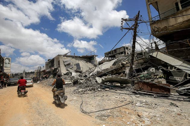 June 15, 2026, Nabatieh, Nabatieh, Lebanon: Lebanese drive their motorcycles devastated buildings in the southern Lebanese city of Nabatieh. Scores of families started to return to their villages following the announcement of an initial ceasefire agreement between the United States and Iran. Nabatieh Lebanon - ZUMAn313 20260615_zip_n313_011 Copyright: xMarwanxNaamanix