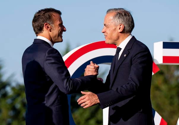 June 15, 2026, Evian-Les-Bains, France: Prime Minister Mark Carney, right, is greeted Emmanuel Macron, President of France, during the G7 summit in Evian-les-Bains, France on Monday, June 15, 2026. Evian-Les-Bains France  - ZUMAc35_ 20260615_zaf_c35_049 Copyright: xChristopherxKatsarovx