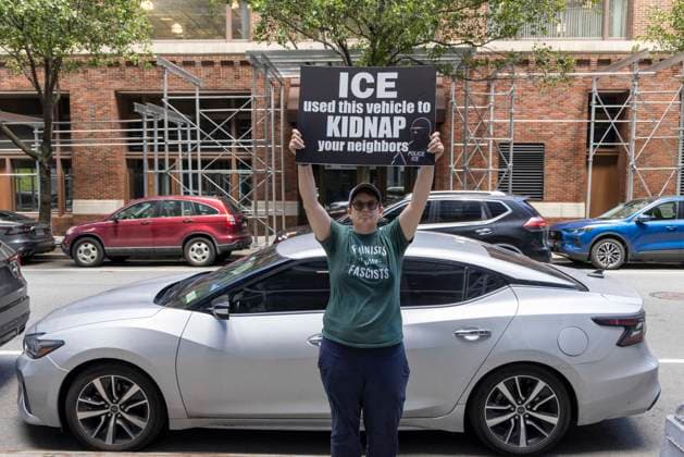 June 15, 2026, New York, New York, USA: An anti-ICE (Immigration Customs and Enforcement) demonstrator holds a sign reading ICE used this vehicle to KIDNAP your neighbors with an image of a masked agent wearing a vest that reads POLICE ICE, identifying a car parked on the street near the Department of Justice Immigration Courts at 201 Varick Street. Recently Border Czar T. Homan threatened to send a surge of immigration agents to New York City after Governor Hochul signed legislation barring state and local law enforcement from working with immigration in New York jails. New York USA - ZUMAr174 20260615_znp_r174_003 Copyright: xGinaxMxRandazzox