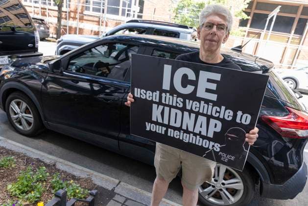 June 15, 2026, New York, New York, USA: An anti-ICE (Immigration Customs and Enforcement) demonstrator holds a sign reading ICE used this vehicle to KIDNAP your neighbors with an image of a masked agent wearing a vest that reads POLICE ICE, identifying a car parked on the street near the Department of Justice Immigration Courts at 201 Varick Street. Recently Border Czar T. Homan threatened to send a surge of immigration agents to New York City after Governor Hochul signed legislation barring state and local law enforcement from working with immigration in New York jails. New York USA - ZUMAr174 20260615_znp_r174_005 Copyright: xGinaxMxRandazzox