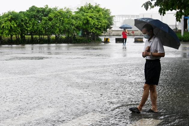 GUANGZHOU, CHINA - JUNE 15: A resident with umbrella walks on a waterlogged road on June 15, 2026 in Guangzhou, Guangdong Province of China. Multiple districts in Guangzhou on June 15 issued orange alert for rainstorms due to continuous influence of strong thunderstorm clouds.  Copyright: xChinaxNewsxServicex 111648333500