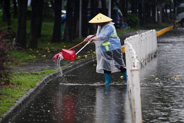 GUANGZHOU, CHINA - JUNE 15: A sanitation worker clears rubbish from a waterlogged road on June 15, 2026 in Guangzhou, Guangdong Province of China. Multiple districts in Guangzhou on June 15 issued orange alert for rainstorms due to continuous influence of strong thunderstorm clouds.  Copyright: xChinaxNewsxServicex 111648333501