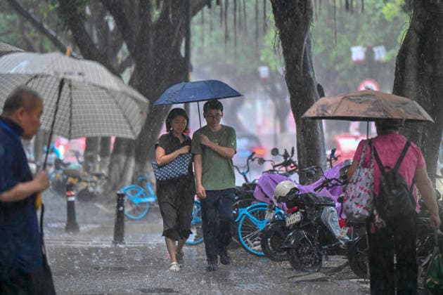 GUANGZHOU, CHINA - JUNE 15: Residents walk in the rain on June 15, 2026 in Guangzhou, Guangdong Province of China. Multiple districts in Guangzhou on June 15 issued orange alert for rainstorms due to continuous influence of strong thunderstorm clouds.  Copyright: xChinaxNewsxServicex 111648333533