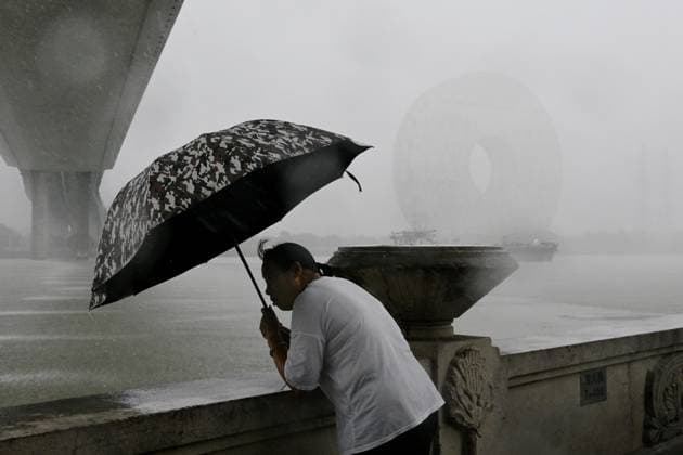 GUANGZHOU, CHINA - JUNE 15: A residents with umbrella looks into the distance in the rain on June 15, 2026 in Guangzhou, Guangdong Province of China. Multiple districts in Guangzhou on June 15 issued orange alert for rainstorms due to continuous influence of strong thunderstorm clouds.  Copyright: xChinaxNewsxServicex 111648333541