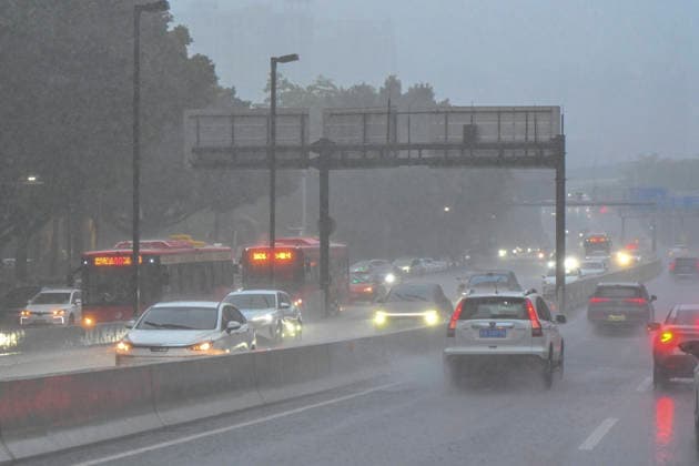 GUANGZHOU, CHINA - JUNE 15: Vehicles drive in the rain on June 15, 2026 in Guangzhou, Guangdong Province of China. Multiple districts in Guangzhou on June 15 issued orange alert for rainstorms due to continuous influence of strong thunderstorm clouds.  Copyright: xChinaxNewsxServicex 111648333142