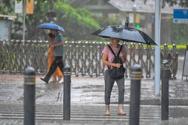 GUANGZHOU, CHINA - JUNE 15: Citizens with umbrellas walk in the rain on June 15, 2026 in Guangzhou, Guangdong Province of China. Multiple districts in Guangzhou on June 15 issued orange alert for rainstorms due to continuous influence of strong thunderstorm clouds.  Copyright: xChinaxNewsxServicex 111648333143