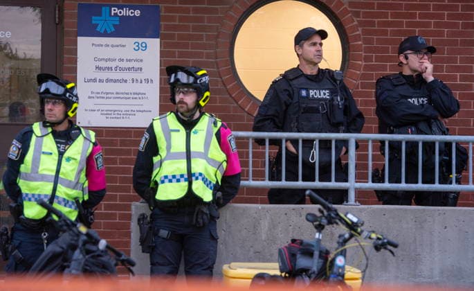 June 15, 2026, Montreal, Pq, Canada: Police watch over Anti police brutality protesters outside Montreal police station 39 in Montreal North during an anti police brutality protest on Monday June 15, 2026. Montreal Canada  - ZUMAc35_ 20260615_zaf_c35_135 Copyright: xPeterxMccabex