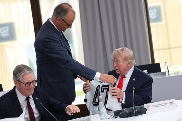 G7 Summit - Merz Presents Trump With German Football Jersey Germany s Chancellor Friedrich Merz presents US President Donald Trump with a German national football team jersey with the number 47 on it as British Prime Minister Keir Starmer looks on during a working session at the G7 summit in Evian-les-Bains, central-eastern France on June 16, 2026. Photo by Dominique Jacovides Pool ABACAPRESS.COM Evian France  Copyright: xJacovidesxDominique Pool ABACAx