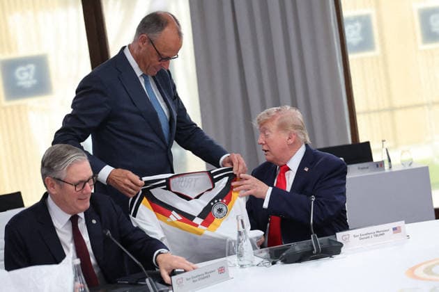 G7 Summit - Merz Presents Trump With German Football Jersey Germany s Chancellor Friedrich Merz presents US President Donald Trump with a German national football team jersey with the number 47 on it as British Prime Minister Keir Starmer looks on during a working session at the G7 summit in Evian-les-Bains, central-eastern France on June 16, 2026. Photo by Dominique Jacovides Pool ABACAPRESS.COM Evian France  Copyright: xJacovidesxDominique Pool ABACAx
