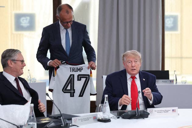 G7 Summit - Merz Presents Trump With German Football Jersey Germany s Chancellor Friedrich Merz presents US President Donald Trump with a German national football team jersey with the number 47 on it as British Prime Minister Keir Starmer looks on during a working session at the G7 summit in Evian-les-Bains, central-eastern France on June 16, 2026. Photo by Dominique Jacovides Pool ABACAPRESS.COM Evian France  Copyright: xJacovidesxDominique Pool ABACAx