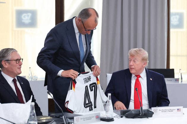 G7 Summit - Merz Presents Trump With German Football Jersey Germany s Chancellor Friedrich Merz presents US President Donald Trump with a German national football team jersey with the number 47 on it as British Prime Minister Keir Starmer looks on during a working session at the G7 summit in Evian-les-Bains, central-eastern France on June 16, 2026. Photo by Dominique Jacovides Pool ABACAPRESS.COM Evian France  Copyright: xJacovidesxDominique Pool ABACAx