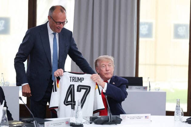 G7 Summit - Merz Presents Trump With German Football Jersey Germany s Chancellor Friedrich Merz presents US President Donald Trump with a German national football team jersey with the number 47 on it as British Prime Minister Keir Starmer looks on during a working session at the G7 summit in Evian-les-Bains, central-eastern France on June 16, 2026. Photo by Dominique Jacovides Pool ABACAPRESS.COM Evian France  Copyright: xJacovidesxDominique Pool ABACAx