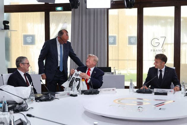 G7 Summit - Merz Presents Trump With German Football Jersey Germany s Chancellor Friedrich Merz presents US President Donald Trump with a German national football team jersey with the number 47 on it as British Prime Minister Keir Starmer looks on during a working session at the G7 summit in Evian-les-Bains, central-eastern France on June 16, 2026. Photo by Dominique Jacovides Pool ABACAPRESS.COM Evian France  Copyright: xJacovidesxDominique Pool ABACAx