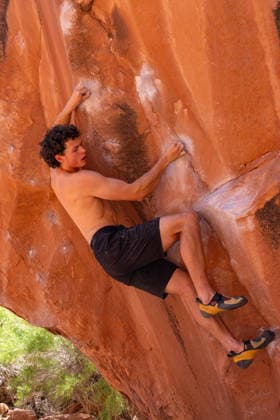 A young male climber bouldering on the Chaos Boulder, Big Bend Bouldering Area near Moab, Utah. Moab Big Bend Bouldering Area Utah United States Copyright: xJonxG.xFullerx xVWPicsx 3985-JGF-climbing-Bouldering-US-UT