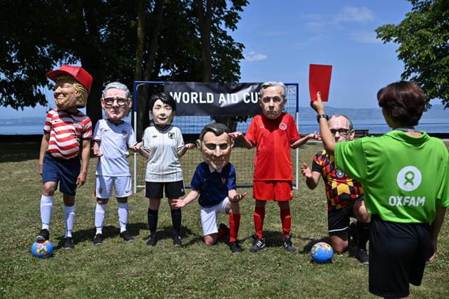 Oxfam protest ahead of G7 Summit in France EVIAN-LES-BAINS, FRANCE - JUNE 16: A referee shows red card to activists wearing oversized papier-mache masks depicting world leaders during an Oxfam demonstration ahead of the G7 Summit near the international media center in Evian-les-Bains, France, on June 16, 2026. Mustafa Yalcin Anadolu Evian-les-Bains France. Editorial use only. Please get in touch for any other usage.  Copyright: x2026xAnadoluxMustafaxYalcinx