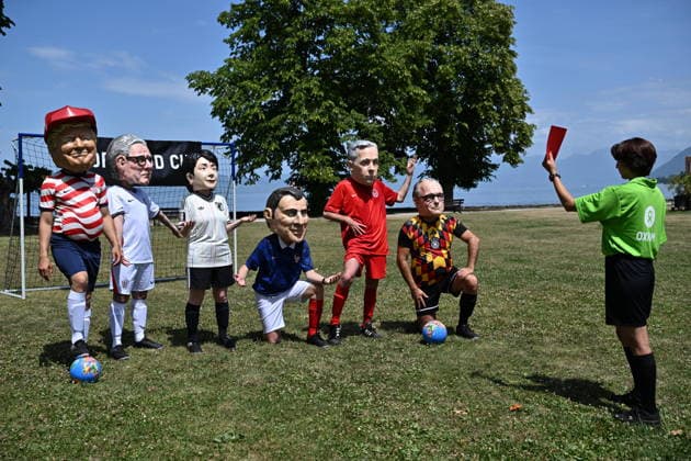 Oxfam protest ahead of G7 Summit in France EVIAN-LES-BAINS, FRANCE - JUNE 16: A referee shows red card to activists wearing oversized papier-mache masks depicting world leaders during an Oxfam demonstration ahead of the G7 Summit near the international media center in Evian-les-Bains, France, on June 16, 2026. Mustafa Yalcin Anadolu Evian-les-Bains France. Editorial use only. Please get in touch for any other usage.  Copyright: x2026xAnadoluxMustafaxYalcinx