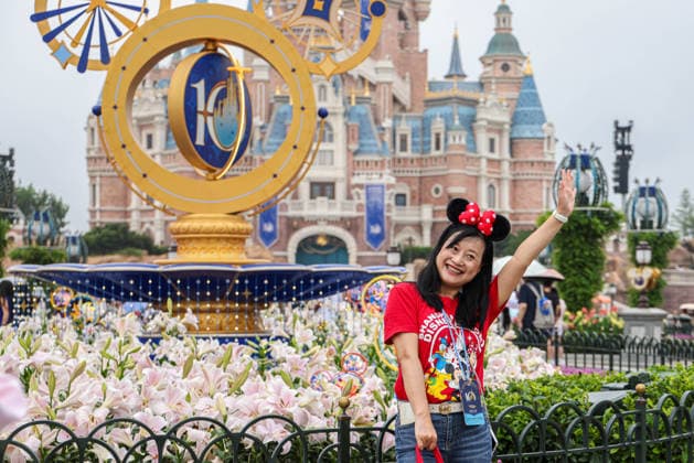 SHANGHAI, CHINA - JUNE 16: Visitors pose for photos with a floral display celebrating the 10th anniversary on June 16, 2026 in Shanghai, China. Shanghai Disney Resort has received over 100 million visits since its opening.  Copyright: xVCGx 111648625137