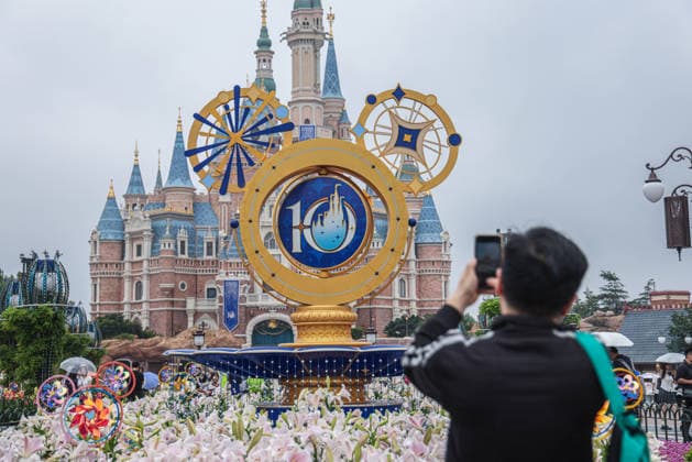 SHANGHAI, CHINA - JUNE 16: Visitors take photos of a floral display themed for the 10th anniversary at Shanghai Disney Resort on June 16, 2026 in Shanghai, China. The theme park has received over 100 million visits since its opening.  Copyright: xVCGx 111648625135