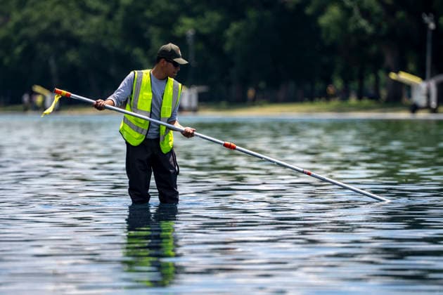 A U.S. National Park Service employee uses a vacuum pump to clean algae off the bottom of the newly repainted Lincoln Memorial Reflecting Pool on the National Mall in Washington, DC on Wednesday, June 17, 2026. The Trump Administration spent $16 million to paint the bottom of the pool American flag blue and as part of an effort to repair Washington landmarks in for preparation the country s 250th birthday this summer.  WAP20260617309 BONNIExCASH