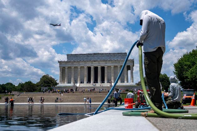 U.S. National Park Service employees use a vacuum pump to clean algae off the bottom of the newly repainted Lincoln Memorial Reflecting Pool on the National Mall in Washington, DC on Wednesday, June 17, 2026. The Trump Administration spent $16 million to paint the bottom of the pool American flag blue and as part of an effort to repair Washington landmarks in for preparation the country s 250th birthday this summer.  WAP20260617322 BONNIExCASH