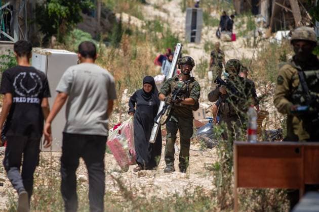 Displaced Families Granted Brief Access to Retrieve Belongings from Tulkarm Camp TULKARM REFUGEE CAMP, WEST BANK JUNE 17, 2026: Palestinian residents carry personal belongings after Israeli authorities allowed 45 families to enter Tulkarm refugee camp for a limited period to retrieve items from their homes. The visit comes amid the ongoing Israeli military operation in Tulkarm and Nur Shams refugee camps, which has displaced large numbers of residents and caused significant damage to homes and infrastructure. Photo by Mojahid Nawahda JNA Press. (Photo by Mojahid Nwahda JNA Press via Nexpher Images) TULKARM