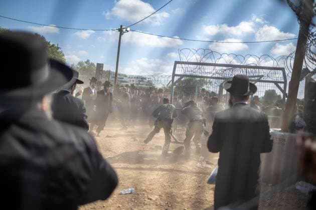 Ultra-Orthodox Jews opposing compulsory military service protest outside an Israeli prison KFAR YONA, ISRAEL - JUNE 17: Thousands of demonstrators gather outside the Beit Lid military prison, calling for the release of an Ultra-Orthodox youth who was arrested for refusing compulsory military service in Kfar Yona, Israel on June 17, 2026. Israeli forces took extensive security measures around the prison during the protest. photo by Roman Levin JNA Press (Photo by Roman Levin JNA Press via Nexpher Images) Kfar Yona