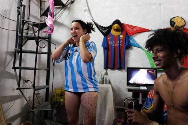 CUBA-HAVANA SOCIAL CRISIS AND WORLD CUP HAVANA, CUBA - JUNE 16, 2026: A woman wearing an Argentina team jersey reacts to the third score of Messi alongside other fans while watching the World Cup match against Algeria inside a home in Havana, Cuba, on June 16, 2026. (Photo by Pablo Miranzo JNA Press via Nexpher Images) HAVANA