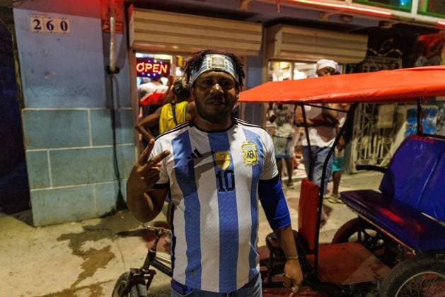 CUBA-HAVANA SOCIAL CRISIS AND WORLD CUP HAVANA, CUBA - JUNE 16, 2026: A footbal fan wearing an Argentina national football team jersey smiles on a street corner while watching the match between Argentina and Argelia in Center Havana,, Cuba, on June 16, 2026. Football culture has grown significantly among Cuban youth, who passionately follow international teams during the World Cup tournament. (Photo by Pablo Miranzo JNA Press via Nexpher Images) HAVANA