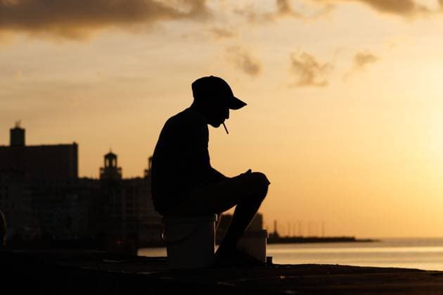 CUBA-HAVANA SOCIAL CRISIS AND WORLD CUP HAVANA, CUBA - JUNE 16, 2026: Silhouette of a guy fishing sitting at the Malecon seawall in Havana, Cuba, on June 16, 2026. The iconic coastal promenade remains a vital space for individual shoreline fishing, which serves as a necessary means of subsistence to secure food for local families. (Photo by Pablo Miranzo JNA Press via Nexpher Images) HAVANA
