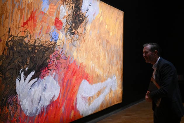 ARTHUR BOYD TAPESTRIES EXHIBITION, A guest takes a look at a tapestry during a media preview of a major winter exhibition ˜Arthur Boyd: Tapestries™ at the National Gallery of Australia in Canberra, Thursday, June 18, 2026. At 2.5 by 3.4 metres, each tapestry features a scene from the life of St Francis of Assisi, one of the most venerated figures in history. ( NO ARCHIVING CANBERRA AUSTRALIAN CAPITAL TERRITORY AUSTRALIA  Copyright: xLUKASxCOCHx 20260618178726226851