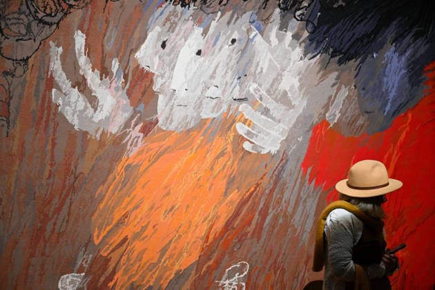 ARTHUR BOYD TAPESTRIES EXHIBITION, A guest takes a look at tapestries during a media preview of a major winter exhibition ˜Arthur Boyd: Tapestries™ at the National Gallery of Australia in Canberra, Thursday, June 18, 2026. At 2.5 by 3.4 metres, each tapestry features a scene from the life of St Francis of Assisi, one of the most venerated figures in history. ( NO ARCHIVING CANBERRA AUSTRALIAN CAPITAL TERRITORY AUSTRALIA  Copyright: xLUKASxCOCHx 20260618116043364650