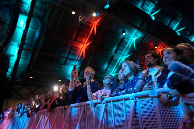 People listen to former President Barack Obama and former first lady Michelle Obama as they speak on stage as they surprised administration and campaign alumni in Chicago ahead of the dedication ceremony of the Obama Presidential Center, Wednesday, June 17, 2026. Pool  CHX20260617220 PabloxMartinezxMonsivais