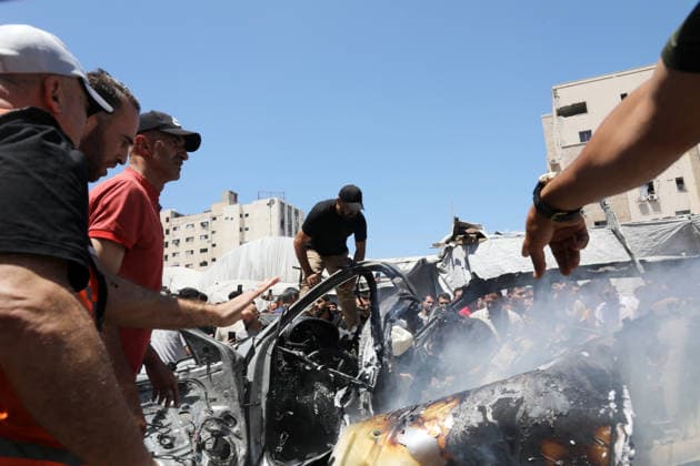 Palestinians Gather at Site of Deadly Vehicle Strike in Gaza City Palestinians and Civil Defense personnel gather around a destroyed vehicle that was targeted in an Israeli airstrike in Gaza City, on June 18, 2026. The strike killed three Palestinians, according to medical sources, and caused significant damage to the vehicle. Photo by Belal Osama apaimages Gaza Gaza Strip Palestinian Territory 180626_Gaza_BO_1_00(20) Copyright: xapaimagesxBelalxOsamax xapaimagesx