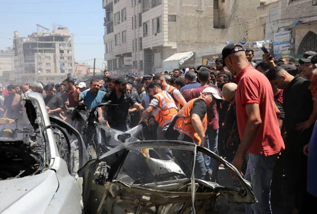 Palestinians Gather at Site of Deadly Vehicle Strike in Gaza City Palestinians and Civil Defense personnel gather around a destroyed vehicle that was targeted in an Israeli airstrike in Gaza City, on June 18, 2026. The strike killed three Palestinians, according to medical sources, and caused significant damage to the vehicle. Photo by Belal Osama apaimages Gaza Gaza Strip Palestinian Territory 180626_Gaza_BO_1_00(21) Copyright: xapaimagesxBelalxOsamax xapaimagesx