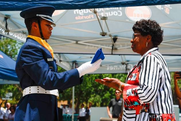 June 18, 2026, Tampa, Florida, USA: Austin Guerrero Cruz, a senior with the Howard W. Blake High School Air Force Junior ROTC, hands the Juneteenth flag to Hillsborough County Commissioner Gwen Myers during the annual Juneteenth Flag-Raising ceremony outside the Fred B. Karl County Center on Thursday, June 18, 2026, in Tampa. Tampa USA - ZUMAs70_ 20260618_zan_s70_004 Copyright: xJeffereexWoox