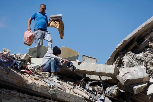 June 18, 2026, Nabatieh District, South Lebanon, lebanon: A family from the town of Kfarreman stands amid the ruins of their destroyed home, sifting through the rubble in search of personal belongings, clothes, and essential items. The scene reflects the heavy toll of recent destruction, as residents attempt to salvage what remains of their daily lives amid widespread damage. Nabatieh District lebanon  - ZUMAb339 20260618_znp_b339_003 Copyright: xAbdulxKaderxAlxBayx