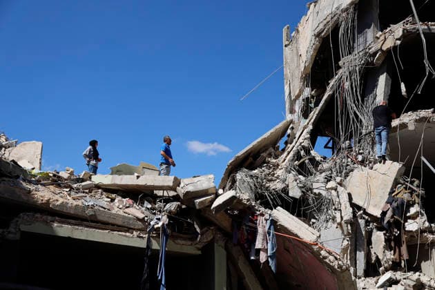June 18, 2026, Nabatieh District, South Lebanon, lebanon: A family from the town of Kfarreman stands amid the ruins of their destroyed home, sifting through the rubble in search of personal belongings, clothes, and essential items. The scene reflects the heavy toll of recent destruction, as residents attempt to salvage what remains of their daily lives amid widespread damage. Nabatieh District lebanon  - ZUMAb339 20260618_znp_b339_012 Copyright: xAbdulxKaderxAlxBayx