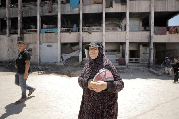 Jabalia Gaza Strip Displacement Crisis A displaced Palestinian woman carries a pot at the Al-Faluja School shelter in Jabalia, in the northern Gaza Strip, on June 18, 2026. Thousands of displaced families in northern Gaza rely on humanitarian assistance as shortages of food, water and basic supplies persist amid the continuing conflict and humanitarian crisis. Gaza Gaza Strip Palestinian Territories Copyright: xAhmedxAlxArinix