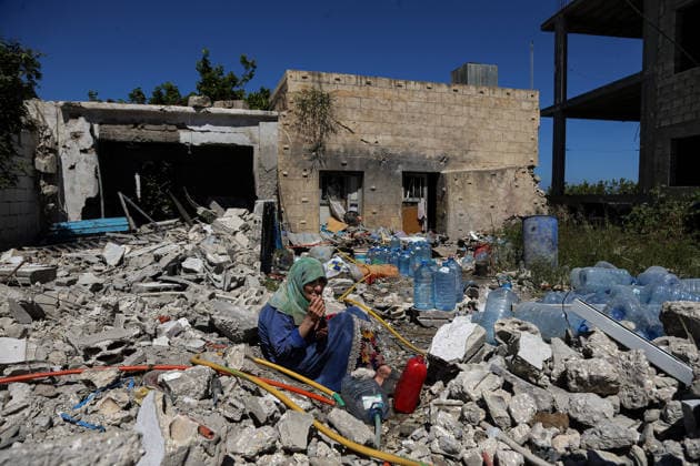 June 19, 2026, Qlalieh, Qlaileh, Lebanon: A Lebanese elderly woman smokes a cigarette as she sits amid wreckage to fill plastic galloons with water from a broken pipe at the southern Lebanese village of Qlaileh. She is one of few people who stayed in the village following overnight Israeli heavy air strikes that left 18 people killed, the country s health ministry has said - while the Israeli military says four of its soldiers were also killed. Scores of Lebanese who returned to their villages early this week again fled the south to safer areas. The heavy attacks come a day after the US and Iran signed a deal aimed at ending the conflict in the Middle East, including a permanent cessation of hostilities in Lebanon. Qlalieh Lebanon - ZUMAn313 20260619_zip_n313_007 Copyright: xMarwanxNaamanix