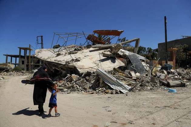 June 19, 2026, Qlalieh, Qlaileh, Lebanon: A Lebanese mother walks with her son near a destroyed home in the devastated southern Lebanese southern village of Qlaileh. She is one of few people that stayed in the hamlet after resident who returned early this week again fled the south to safer areas following overnight Israeli heavy air strikes that left 18 people killed, the country s health ministry has said - while the Israeli military says four of its soldiers were also killed. The heavy attacks come a day after the US and Iran signed a deal aimed at ending the conflict in the Middle East, including a permanent cessation of hostilities in Lebanon. Qlalieh Lebanon  - ZUMAn313 20260619_zip_n313_010 Copyright: xMarwanxNaamanix